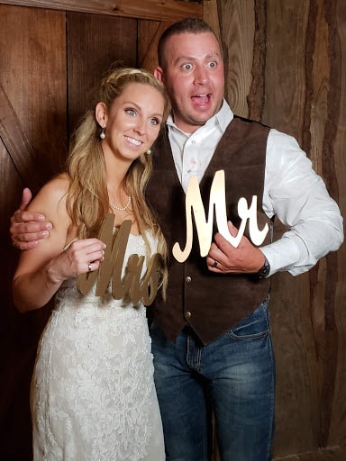 The newlyweds at the rustic wedding photo booth! 
